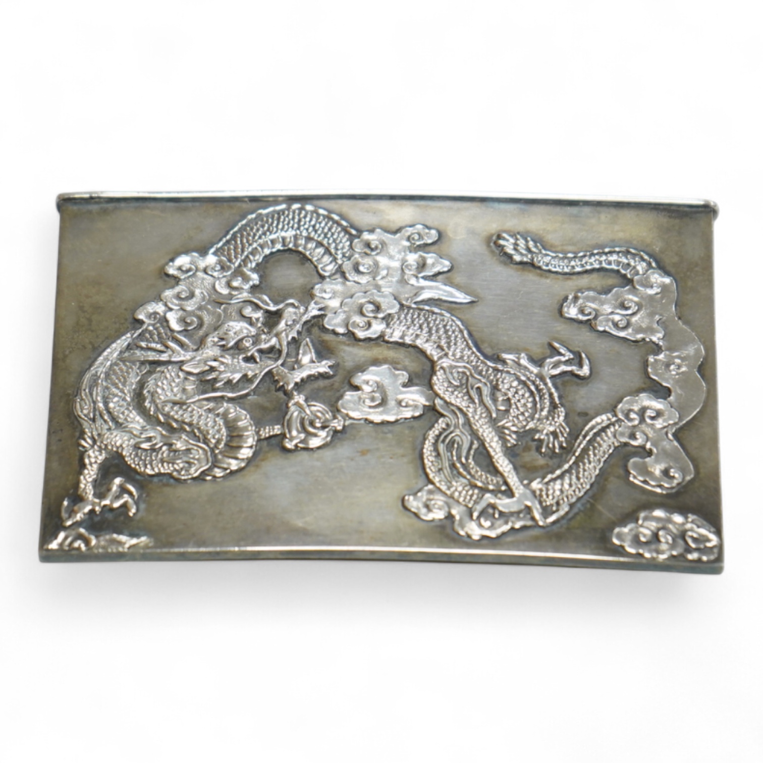 A Japanese Meiji period white metal card case, with applied dragon decoration, jungin mark, 90mm by 55mm.